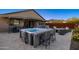 Backyard patio featuring a hot tub with bar seating and comfortable outdoor furniture, ideal for entertaining at 12269 E Chiricahua Pl, Gold Canyon, AZ 85118