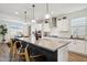 Spacious kitchen with a large island offering seating, granite countertops, and seamless flow into the dining area at 12269 E Chiricahua Pl, Gold Canyon, AZ 85118