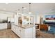 Open layout features a modern kitchen with granite countertops, stainless steel appliances, and seamless flow into the living area at 12269 E Chiricahua Pl, Gold Canyon, AZ 85118