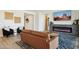 Bright open living room offering stylish decor, wood-look floors, and a contemporary fireplace with television at 12269 E Chiricahua Pl, Gold Canyon, AZ 85118