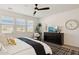 A well-lit main bedroom includes a large window, a ceiling fan, and a stylish dresser with modern decor at 12269 E Chiricahua Pl, Gold Canyon, AZ 85118