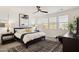 Well-lit main bedroom with a ceiling fan, neutral tones, a large window, and stylish decor at 12269 E Chiricahua Pl, Gold Canyon, AZ 85118
