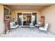 Covered patio with neutral tile flooring, comfortable seating, and unique art sculptures, a great outdoor space at 12269 E Chiricahua Pl, Gold Canyon, AZ 85118