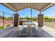 Inviting covered picnic area with BBQ, table and seating, perfect for outdoor gatherings at 12269 E Chiricahua Pl, Gold Canyon, AZ 85118