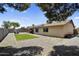 Expansive backyard with a grassy area, gravel landscaping, and a covered patio at 12447 N 50Th Ln, Glendale, AZ 85304