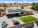Spacious backyard with covered patio, solar panels, outdoor seating, green area, and block fence at 12447 N 50Th Ln, Glendale, AZ 85304