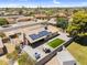 Aerial view showcasing a large backyard with a patio, green area, and solar panels at 12447 N 50Th Ln, Glendale, AZ 85304