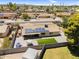 Expansive fenced backyard with patio, solar panels, artificial grass, and recreational space at 12447 N 50Th Ln, Glendale, AZ 85304