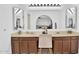 Bathroom vanity featuring double sinks, ample lighting, and a seated vanity at 12447 N 50Th Ln, Glendale, AZ 85304