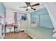 Bright bedroom featuring a four-poster bed, ceiling fan, TV, and charming décor at 12447 N 50Th Ln, Glendale, AZ 85304