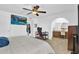 Comfortable bedroom with a ceiling fan, TV, workstation and ensuite bathroom at 12447 N 50Th Ln, Glendale, AZ 85304