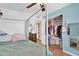Cozy bedroom with a four-poster bed, ceiling fan, and organized closet space at 12447 N 50Th Ln, Glendale, AZ 85304