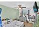 Playful bedroom showcasing a dinosaur theme, TV, and ceiling fan at 12447 N 50Th Ln, Glendale, AZ 85304