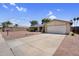 Front exterior featuring a well-kept lawn and a two-car garage at 12447 N 50Th Ln, Glendale, AZ 85304