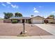 Charming single-story home with a well-manicured yard and solar panels on the roof at 12447 N 50Th Ln, Glendale, AZ 85304