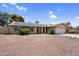 Welcoming front exterior of home with solar panels, lush shrubbery, and low-maintenance landscaping at 12447 N 50Th Ln, Glendale, AZ 85304