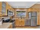 A bright kitchen with stainless steel appliances, light wood cabinets, and a window overlooking the backyard at 12447 N 50Th Ln, Glendale, AZ 85304