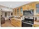 Well-lit kitchen boasting modern appliances, and bright wooden cabinetry at 12447 N 50Th Ln, Glendale, AZ 85304
