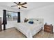 Serene main bedroom with hardwood floors, a comfortable queen-sized bed, and ample natural light at 12447 N 50Th Ln, Glendale, AZ 85304