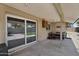 Covered patio with a sliding door, dining area, and outdoor access at 12447 N 50Th Ln, Glendale, AZ 85304