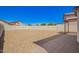 Wide open backyard space featuring a desert landscape with rock cover and a patio at 12506 W Corrine Dr, El Mirage, AZ 85335