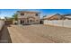 Desert landscaping in the backyard with a covered patio area attached to the home at 12506 W Corrine Dr, El Mirage, AZ 85335