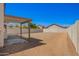 Covered patio area in the backyard overlooking desert landscaping and a block wall fence at 12506 W Corrine Dr, El Mirage, AZ 85335