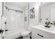 This newly remodeled bathroom has bright white tiles and black fixtures for a modern contrast at 12506 W Corrine Dr, El Mirage, AZ 85335
