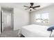 Bright bedroom with a ceiling fan and a window overlooking neighborhood views at 12506 W Corrine Dr, El Mirage, AZ 85335