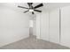 This bedroom features a modern ceiling fan and a closet with sliding doors for efficient storage at 12506 W Corrine Dr, El Mirage, AZ 85335