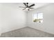 Bright bedroom with carpet, ceiling fan, and ample natural light from a window at 12506 W Corrine Dr, El Mirage, AZ 85335