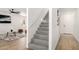 Bright entryway featuring modern flooring and staircase leading to upper level at 12506 W Corrine Dr, El Mirage, AZ 85335