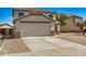 Exterior shot showing two-story home with front-facing garage and desert landscaping at 12506 W Corrine Dr, El Mirage, AZ 85335
