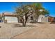 Side view of two story house with desert landscaping and driveway leading to the garage at 12506 W Corrine Dr, El Mirage, AZ 85335