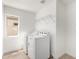 Convenient laundry room features a modern washer and dryer with a storage shelf at 12506 W Corrine Dr, El Mirage, AZ 85335