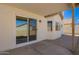 Relaxing covered patio area with tiled flooring and sliding glass door access to the home at 12506 W Corrine Dr, El Mirage, AZ 85335