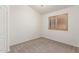 Carpeted bedroom with ample light and wood shuttered window at 13145 W Cambridge Ave, Goodyear, AZ 85395
