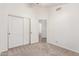 This bedroom is spacious and features neutral carpeting and a closet, creating a comfortable and relaxing space at 13145 W Cambridge Ave, Goodyear, AZ 85395