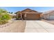 Charming single-story home with a well-maintained front yard, desert landscaping, and a two-car garage at 13145 W Cambridge Ave, Goodyear, AZ 85395