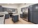 Well-lit kitchen features gray cabinets, stainless steel appliances, and granite countertops at 13145 W Cambridge Ave, Goodyear, AZ 85395