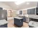 Modern kitchen featuring sleek stainless steel appliances, granite countertops, and center island at 13145 W Cambridge Ave, Goodyear, AZ 85395