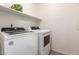 Functional laundry room with side by side washer and dryer and built in shelf at 13145 W Cambridge Ave, Goodyear, AZ 85395
