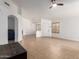 Open living space featuring tile floors, neutral paint, shutters, and seamless flow for relaxation at 13145 W Cambridge Ave, Goodyear, AZ 85395