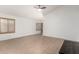 Bright living space with neutral walls, tile flooring, shuttered windows, and great natural light at 13145 W Cambridge Ave, Goodyear, AZ 85395
