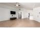 Spacious living room featuring tile flooring, ceiling fan, and a large wall for entertainment center at 13145 W Cambridge Ave, Goodyear, AZ 85395