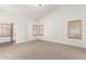 Sunlit bedroom boasts neutral carpet, vaulted ceilings, and private access to the patio at 13145 W Cambridge Ave, Goodyear, AZ 85395