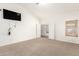 Open bedroom with neutral carpet, vaulted ceilings, and abundant natural light at 13145 W Cambridge Ave, Goodyear, AZ 85395