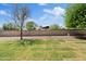 Spacious backyard with grass area, mature trees, and block wall for privacy at 13816 N 46Th St, Phoenix, AZ 85032