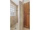 Shower includes glass blocks for light, with tile walls and built in storage at 13816 N 46Th St, Phoenix, AZ 85032