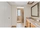 A neutral bathroom featuring a double sink vanity and glass block shower at 13816 N 46Th St, Phoenix, AZ 85032
